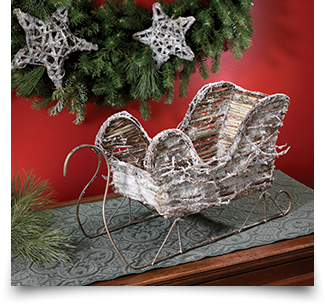 Bouquet & Company frosted decorative sleigh setting on an antique dresser